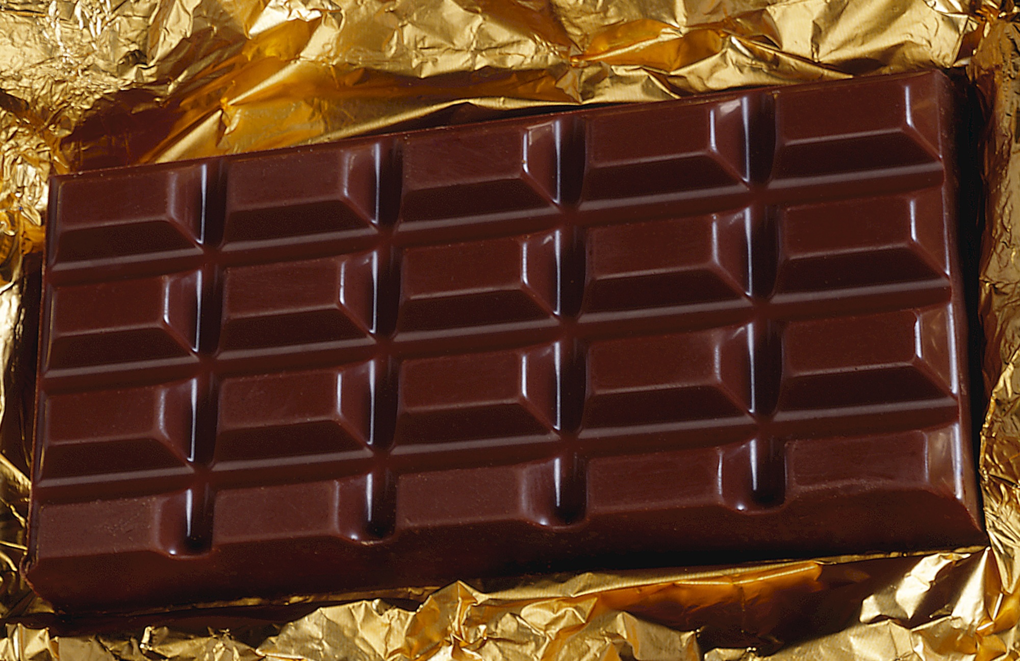 Dark chocolate bar on gold foil